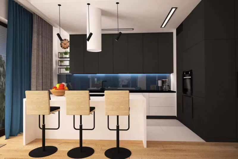 Kuchnia czarnymi szafkami, białym stołem i trzeba białymi, wysokimi krzesłami. Podłoga biała w kuchni i koloru drewna na wejściu do kuchni. Po lewej stronie niebieska kotara, zasłaniające duże okno.