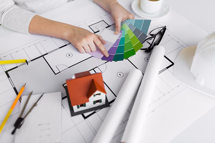 Architekt wybierający kolory z próbnika nad projektem wnętrza mieszkania.
