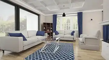 Elegancki salon z jasnymi sofami, granatowymi dodatkami i nowoczesnym stolikiem kawowym w aranżacji