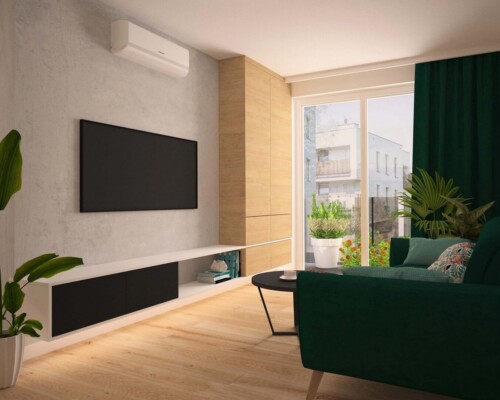 Akcent koloru i natury – strefa relaksu w salonie, gdzie zieleń gra pierwsze skrzypce. Nowoczesny salon z czarną szafką RTV, wygodnym fotelem w kolorze butelkowej zieleni i dużą rośliną doniczkową.