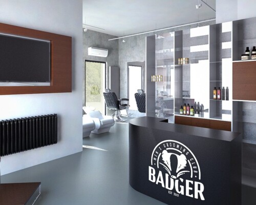 Stylowa recepcja w salonie Badger – minimalistyczny design i ekspozycja kosmetyków Recepcja nowoczesnego salonu barberskiego z półkami i logotypem Badger