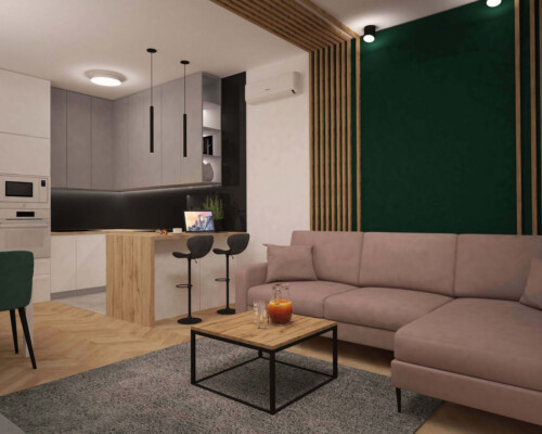 Przestrzeń dzienna z kuchnią i salonem – nowoczesność w eleganckim wydaniu Salon z aneksem kuchennym, różową sofą i czarnymi detalami