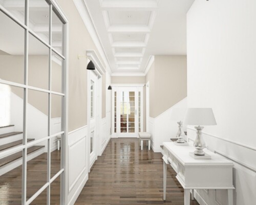 Otwarta przestrzeń, spójny design – harmonia strefy wypoczynkowej z komunikacyjną. Jasny salon z białą kanapą i widokiem na nowoczesne, ażurowe schody prowadzące na piętro.