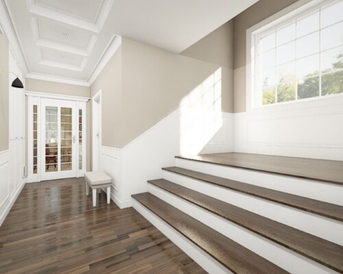 Rzeźba w centrum domu – schody jako lekki i świetlisty element architektoniczny. Nowoczesne, białe schody z drewnianymi stopniami i szklaną balustradą w jasnym wnętrzu.