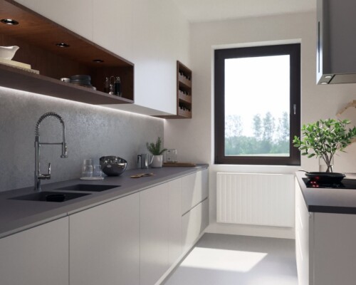 Kuchnia pełna światła – minimalistyczny design w jasnej i przestronnej aranżacji. Szerokie ujęcie na jasną, białą kuchnię z szarym blatem i dużym oknem.