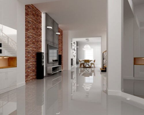 Loftowy klimat w salonie – ceglana ściana jako idealne tło dla nowoczesnej strefy multimedialnej. Salon w stylu loftowym ze ścianą telewizyjną wykończoną czerwoną cegłą i nowoczesną szafką RTV.