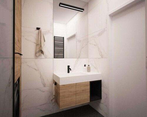 Ponadczasowe połączenie w łazience – elegancja białego marmuru i ciepło naturalnego drewna. Fragment łazienki z drewnianą szafką podumywalkową, nablatową umywalką i ścianą z białego marmuru.
