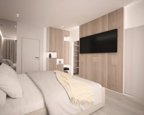 Funkcjonalna sypialnia – miejsce do snu i pracy Nowoczesna sypialnia z telewizorem, biurkiem i zabudową z drewna