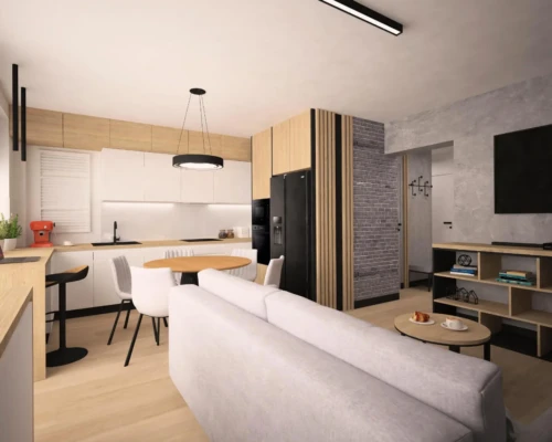 Wspólna przestrzeń – kuchnia i salon w harmonii Salon z kuchnią w otwartej przestrzeni, jasna zabudowa i sofa w centrum