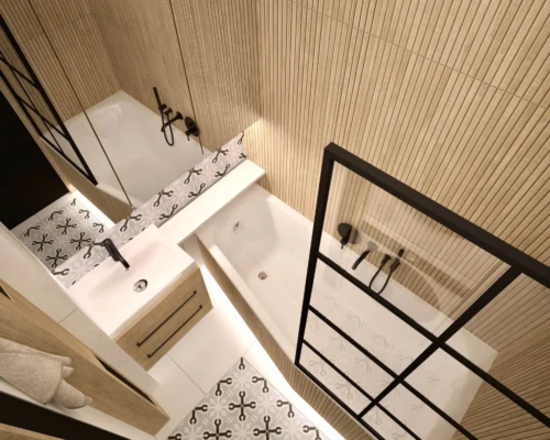 Ciepło drewna i siła kontrastu – łazienka z charakterem Łazienka z drewnianym wykończeniem, czarnymi przeszkleniami i mozaiką na podłodze